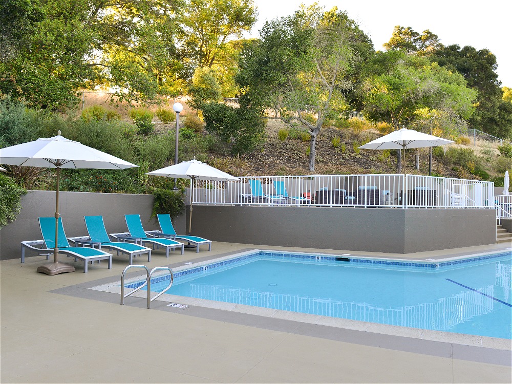 Hotel outdoor pool with lounge chairs and umbrellas